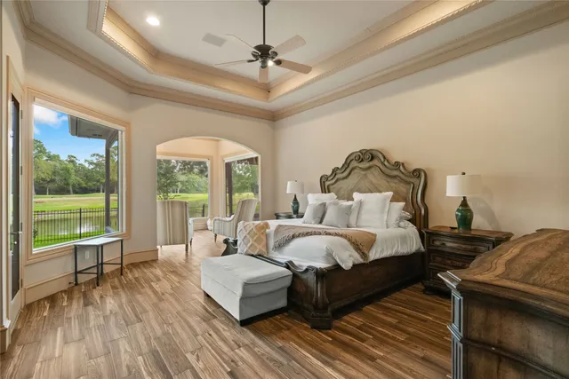 a bedroom with a bed and a large window