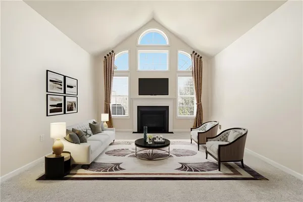 a view of a livingroom with furniture and a ceiling fan
