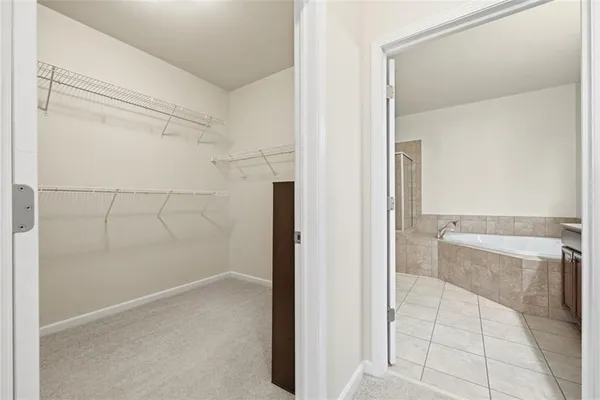 a view of a hallway with wooden floor and closet