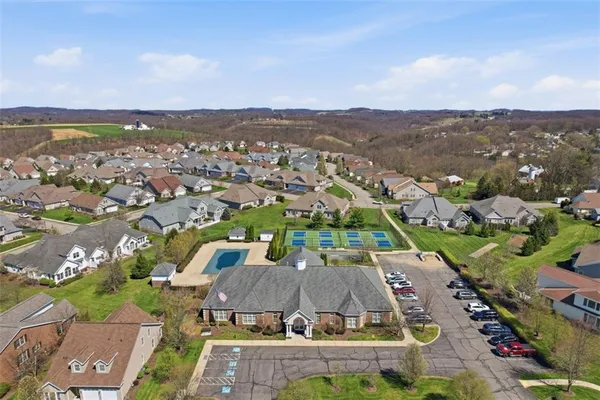 an aerial view of a city with lots of residential buildings and mountain view in back