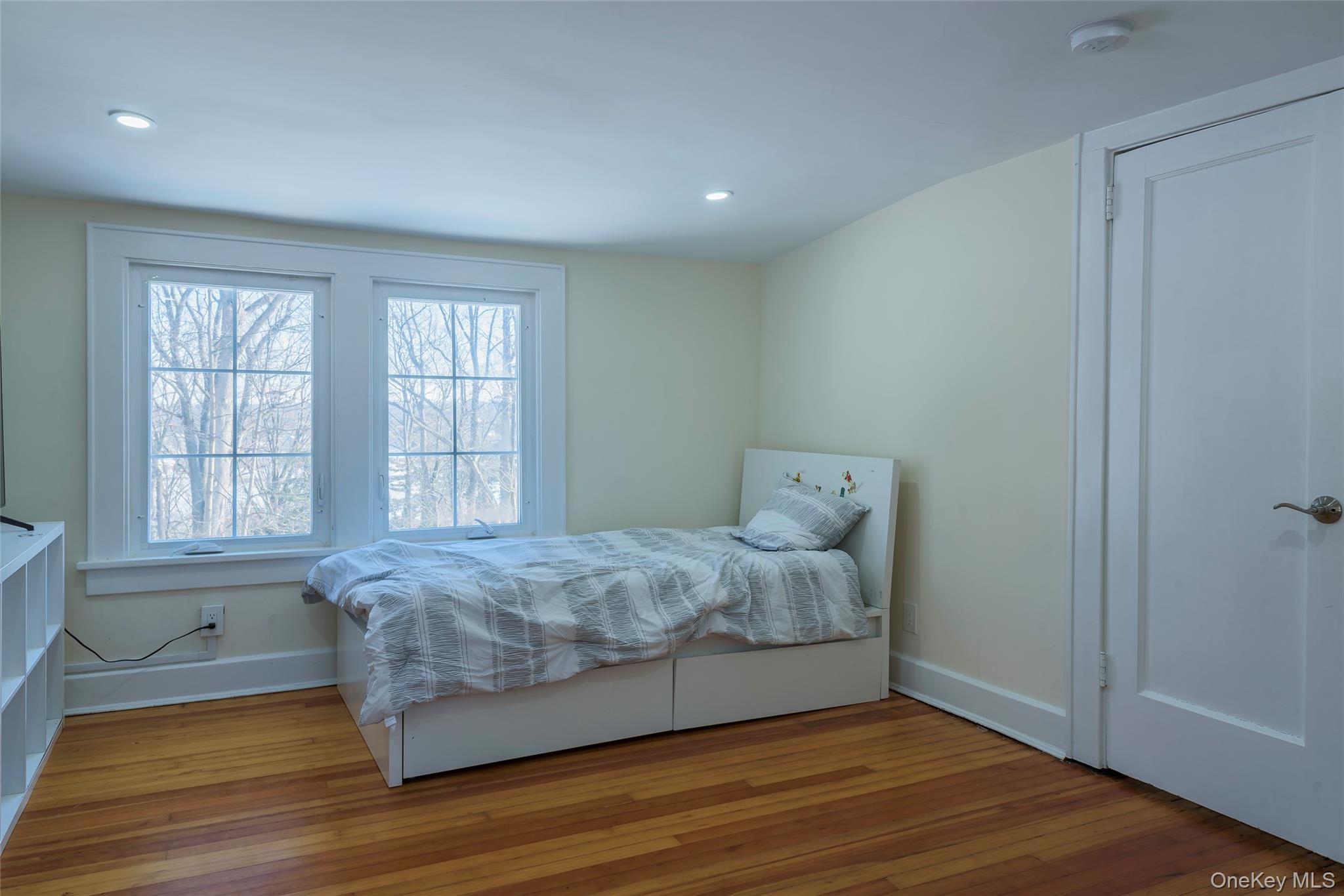 20 North Ravine Road Great Neck, NY 11023 - Photo 23 of 27 a spacious bedroom with a bed and wooden floor
