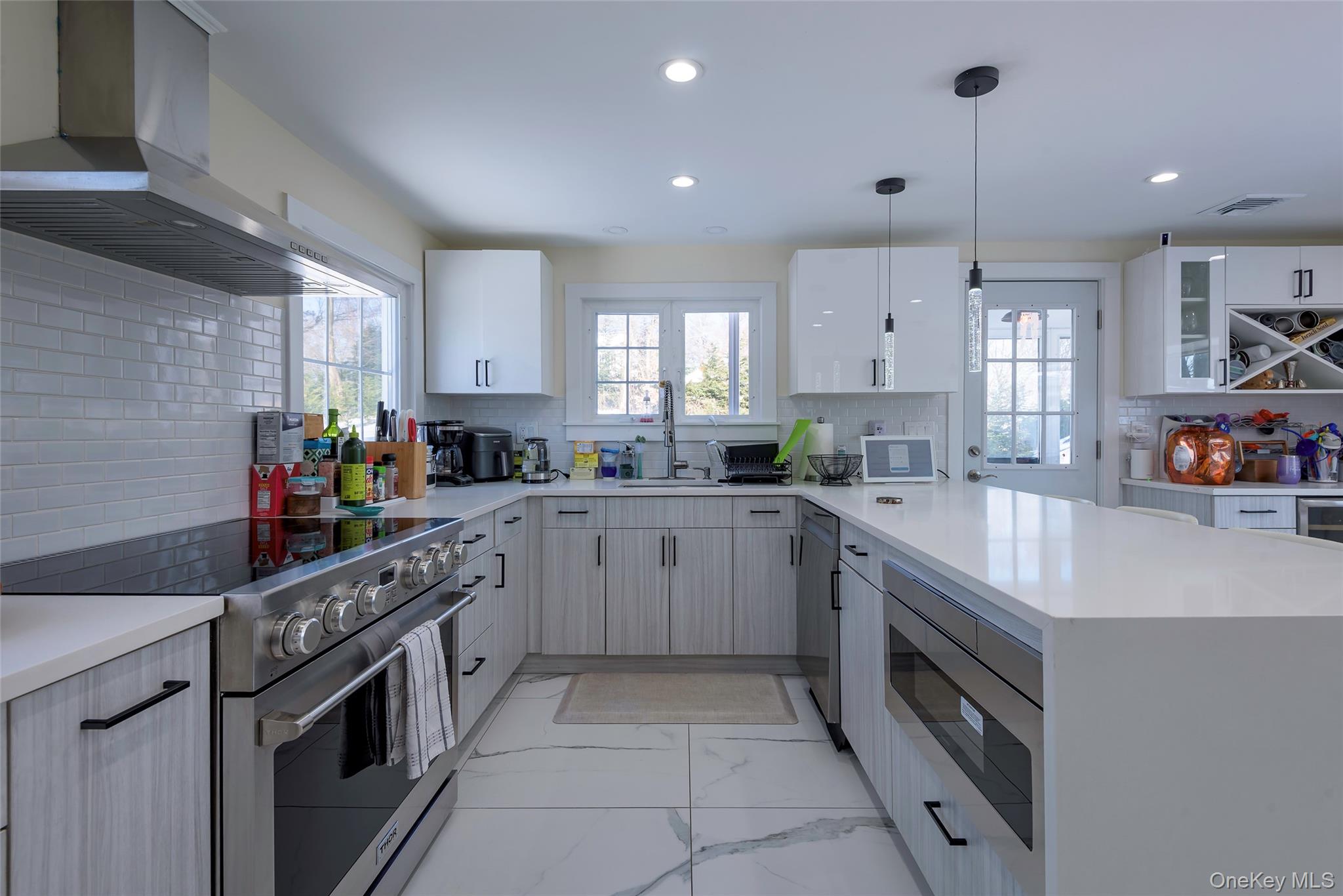 20 North Ravine Road Great Neck, NY 11023 - Photo 9 of 27 a kitchen with stainless steel appliances granite countertop a stove a sink and a refrigerator