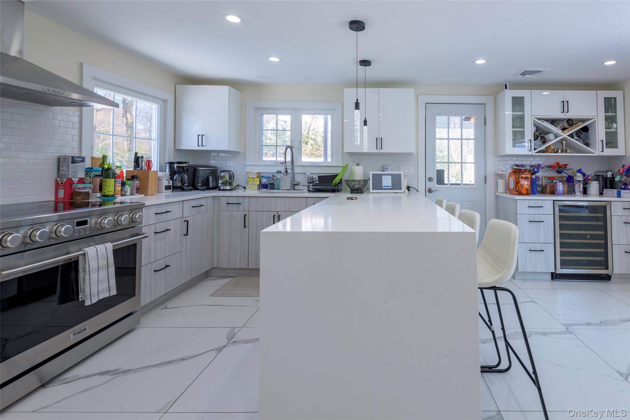 20 North Ravine Road Great Neck, NY 11023 - Photo 10 of 27 a kitchen with stainless steel appliances a stove a sink and a refrigerator