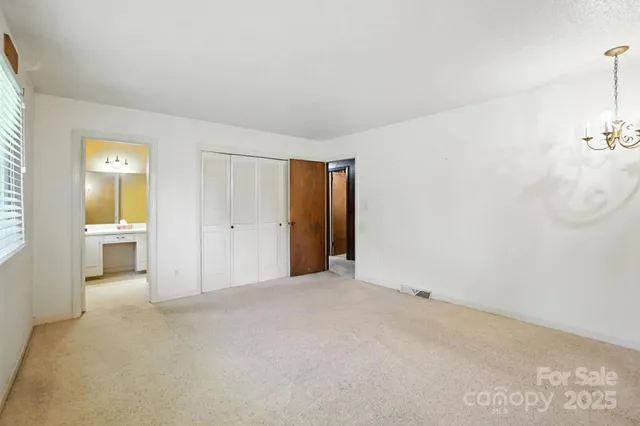 a view of a livingroom and a bathroom with a sink