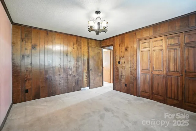 a spacious bathroom with a chandelier fan and shower