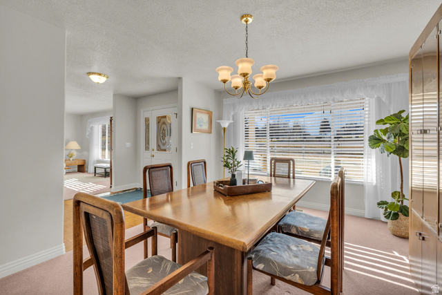 1060 West 2620th Street South Mapleton, UT 84664 - Photo 11 of 87 Dining area featuring light carpet, a textured ceiling, suspended lighting, and plenty of natural light