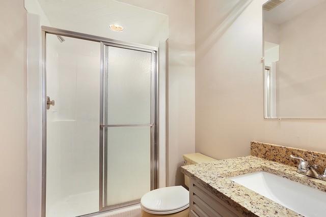 3033 East Hickory Lane Crete, IL 60417 - Photo 15 of 18 a bathroom with a granite countertop sink toilet and shower