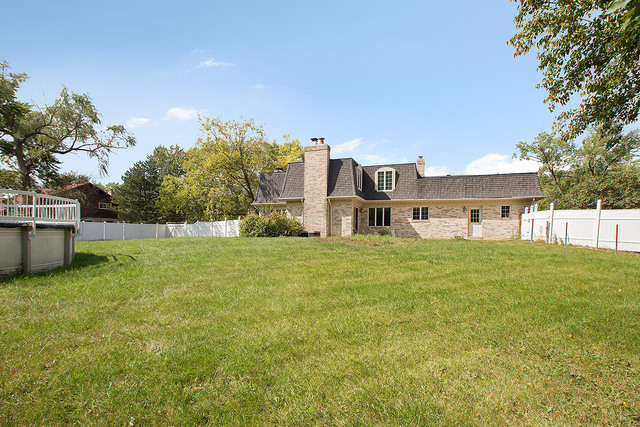 3033 East Hickory Lane Crete, IL 60417 - Photo 18 of 18 a front view of house with yard and trees in the background