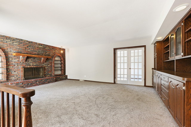 3033 East Hickory Lane Crete, IL 60417 - Photo 5 of 18 a view of an empty room with a fireplace and a window