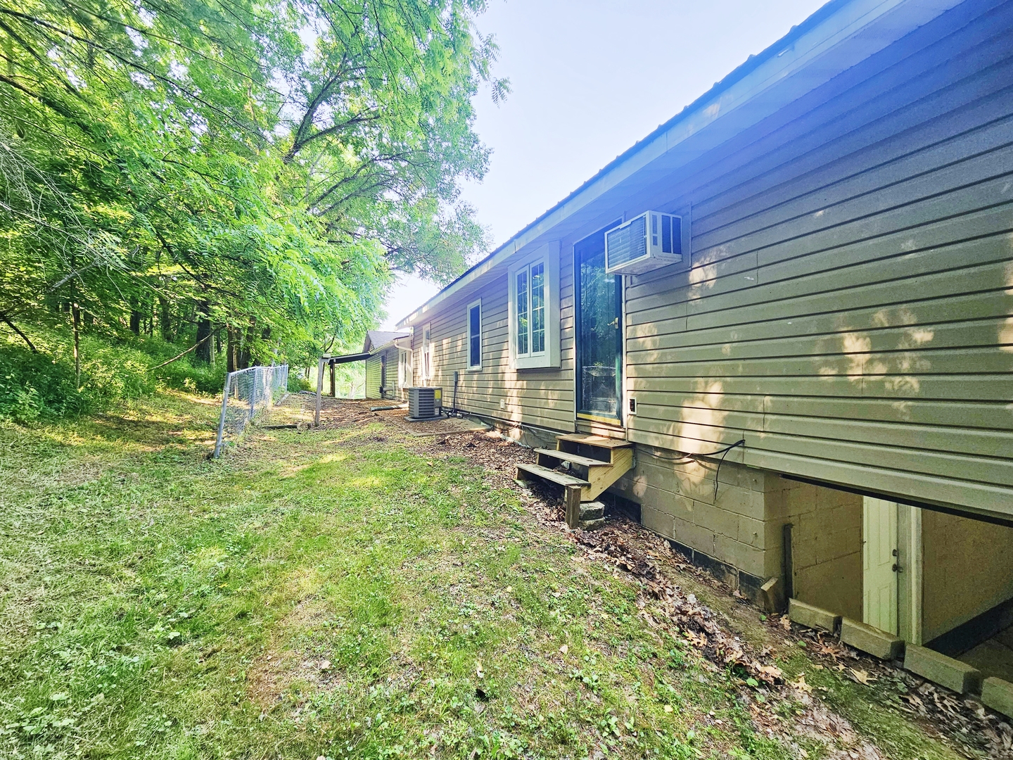 16710 Browns Road Morrison, IL 61270 - Photo 2 of 39 a view of backyard with a table and chairs and wooden fence
