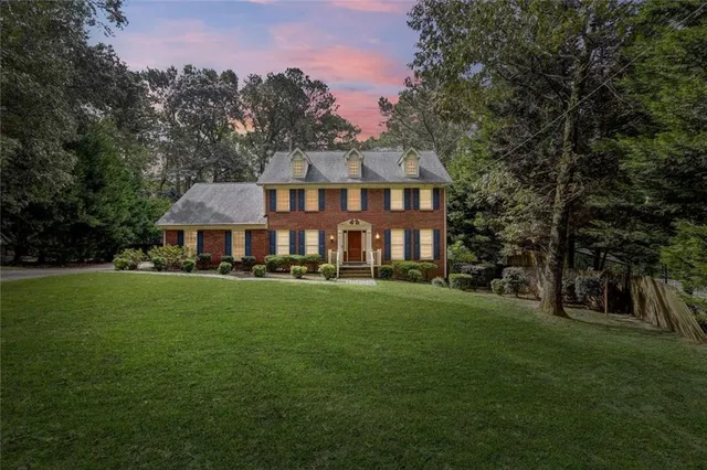 a front view of a house with a garden