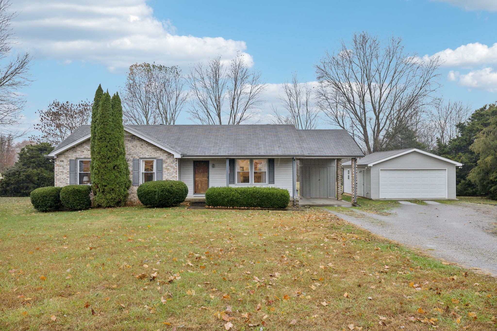 3328 Beckwith Road Mount Juliet, TN 37122 - Photo 1 of 18 a view of a brick house with a big yard and large trees