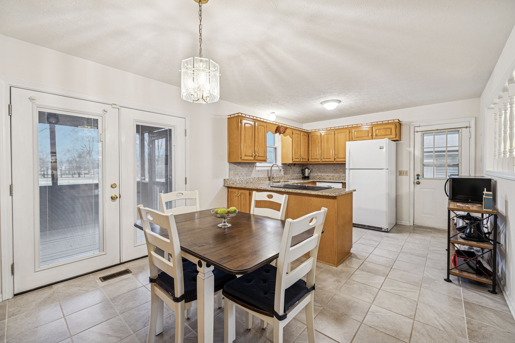 3328 Beckwith Road Mount Juliet, TN 37122 - Photo 6 of 18 a kitchen with refrigerator cabinets dining table and chairs