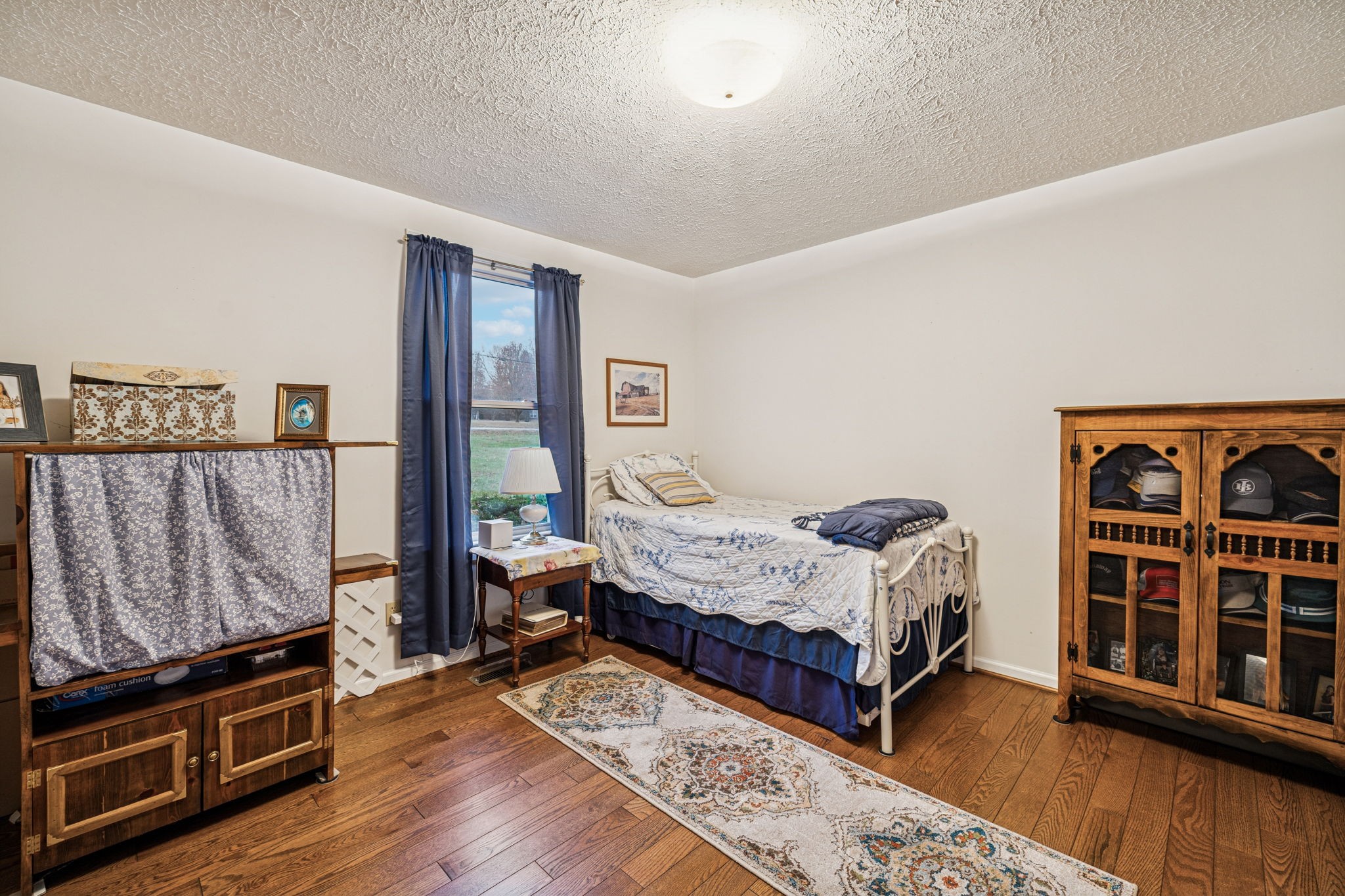 3328 Beckwith Road Mount Juliet, TN 37122 - Photo 10 of 18 a bedroom with a bed bookshelf and a large window
