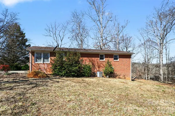 a front view of house with yard and trees around