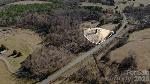 a bird view of a house next to a yard