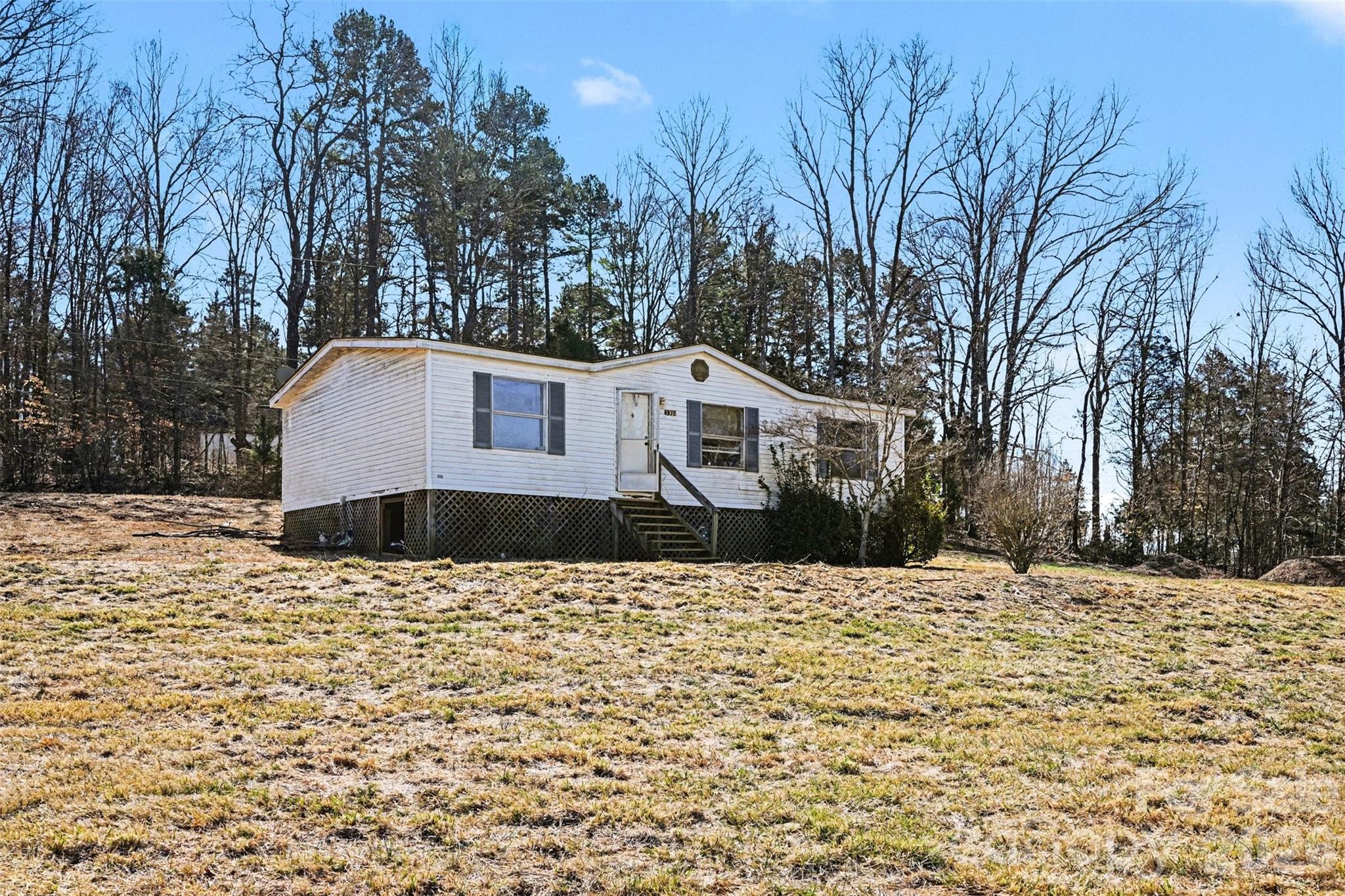 4650 Windy Road Concord, NC 28027 - Photo 24 of 34 a front view of a house with a yard covered with snow