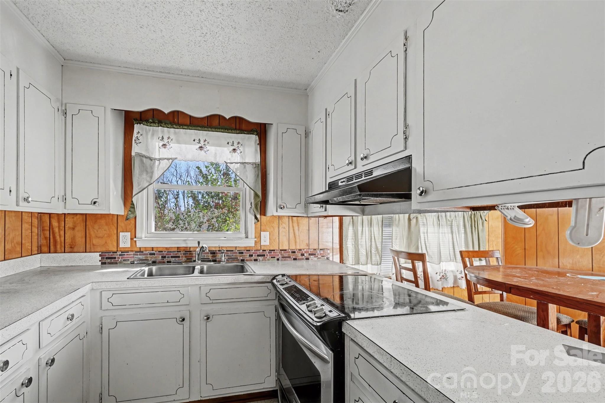 4650 Windy Road Concord, NC 28027 - Photo 3 of 34 a kitchen with stainless steel appliances granite countertop a sink a stove and a wooden cabinets