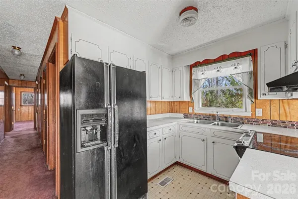 a kitchen with stainless steel appliances a sink stove and refrigerator