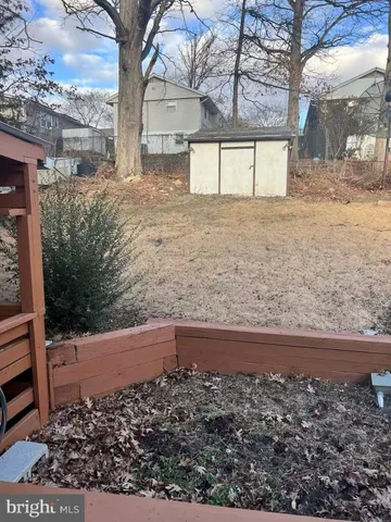 a view of a patio with table and chairs a barbeque with wooden floor and roof