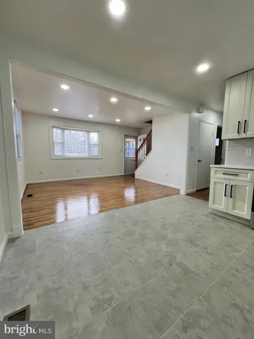 a bathroom with a granite countertop sink a toilet and a mirror