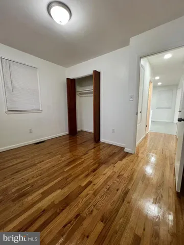 a view of an empty room and wooden floor