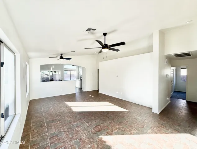 a view of a livingroom with wooden floor and a ceiling fan