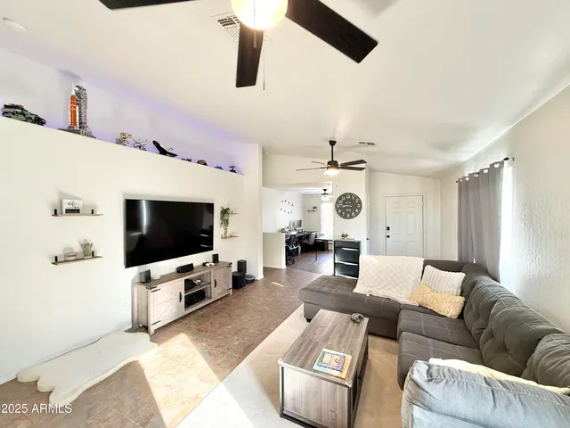 a living room with furniture and a flat screen tv