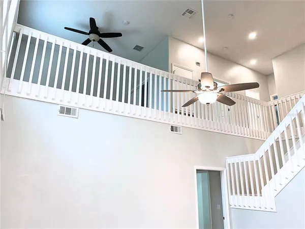 a view of staircase with white walls and a window