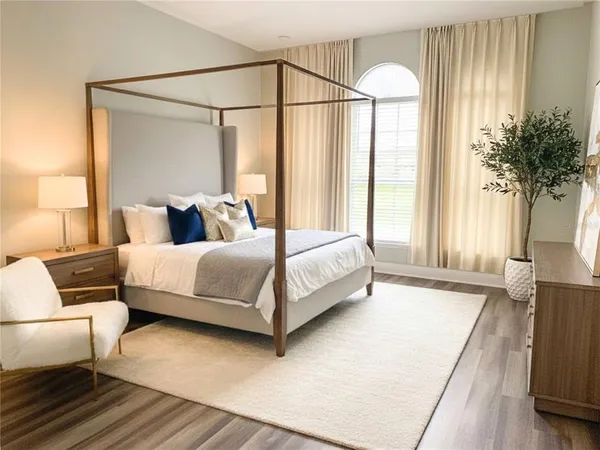 a bedroom with a bed lamps and window