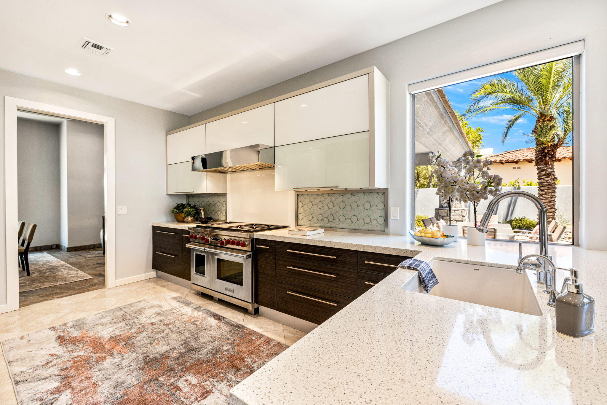 28 Clancy Lane South Rancho Mirage, CA 92270 - Photo 21 of 78 a kitchen with stainless steel appliances kitchen island granite countertop a sink stove and granite counter top