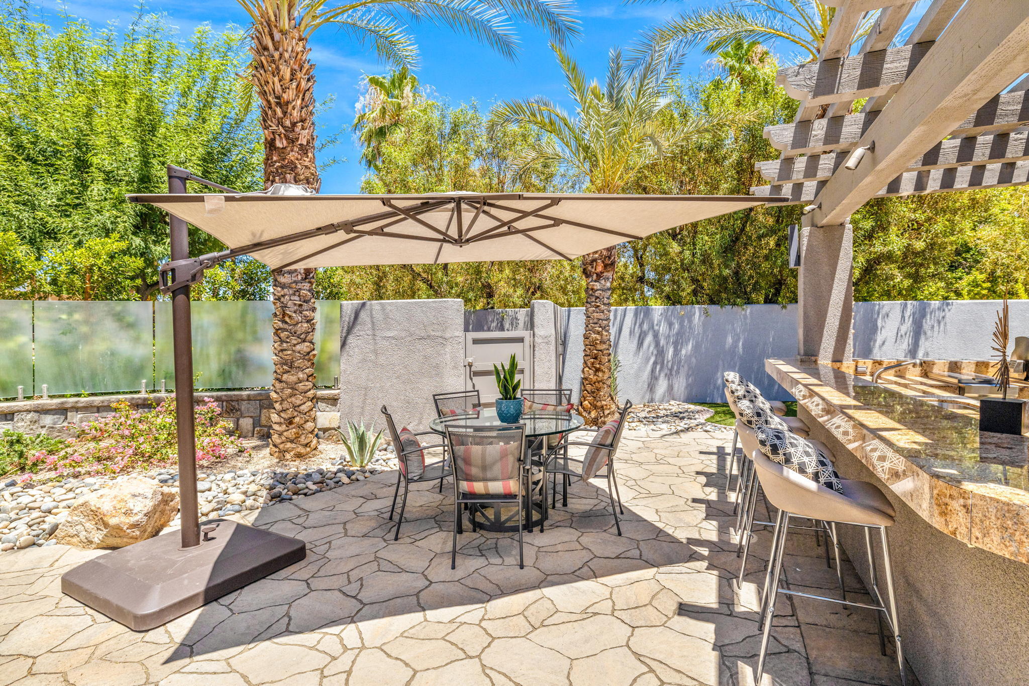 28 Clancy Lane South Rancho Mirage, CA 92270 - Photo 70 of 78 a view of a patio with a table and chairs under an umbrella