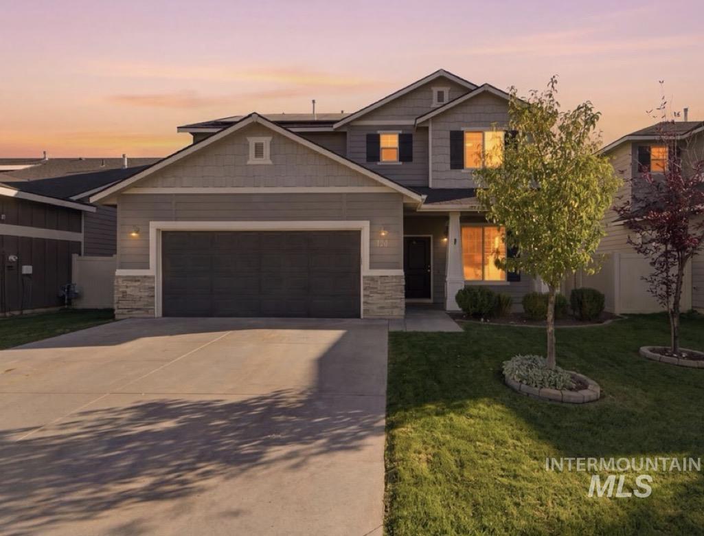 124 South Sunset Point Way Meridian, ID 83642 - Photo 2 of 24 Two-story exterior with horizontal siding and shingle accents, stone veneer detailing, and an attached two-car garage