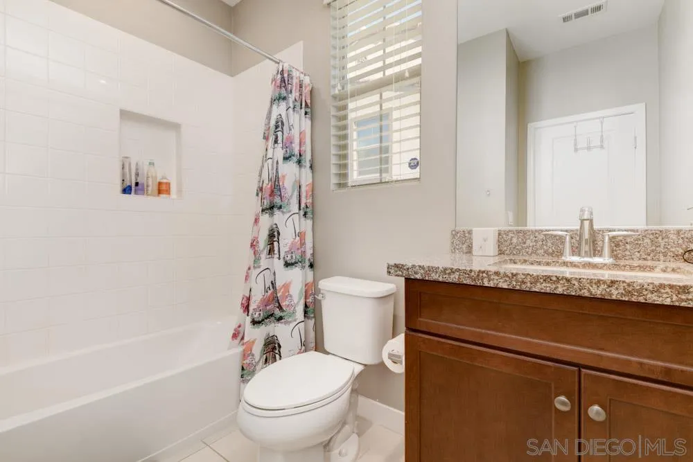 7508 Eagle Drive Santee, CA 92071 - Photo 15 of 25 a bathroom with a granite countertop toilet a sink and a bathtub
