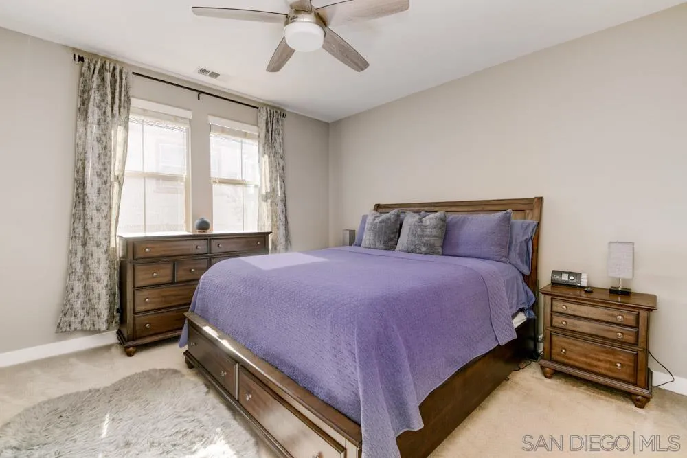 7508 Eagle Drive Santee, CA 92071 - Photo 18 of 25 a bedroom with a bed and a chandelier