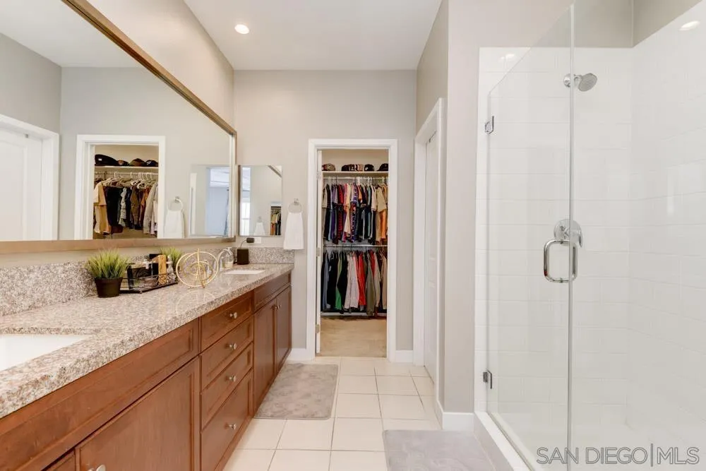 7508 Eagle Drive Santee, CA 92071 - Photo 20 of 25 a large bathroom with a granite countertop sink a mirror and a bath tub