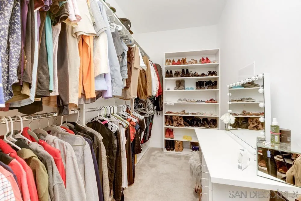 7508 Eagle Drive Santee, CA 92071 - Photo 21 of 25 a view of walk in closet with clothes and shoes