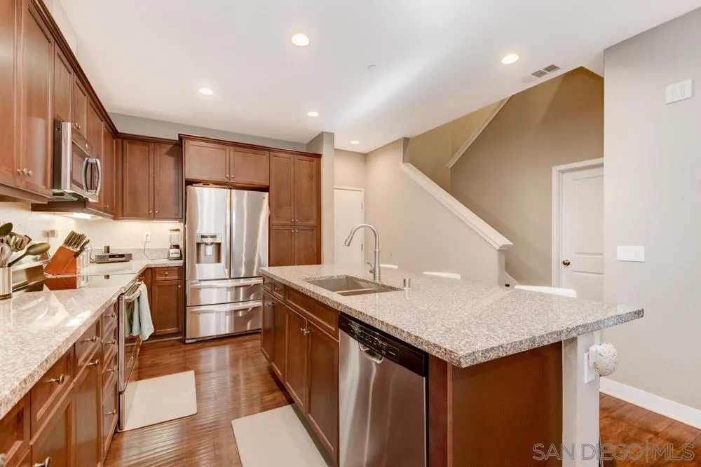 7508 Eagle Drive Santee, CA 92071 - Photo 10 of 25 a kitchen with stainless steel appliances granite countertop a kitchen island a stove a refrigerator and a sink