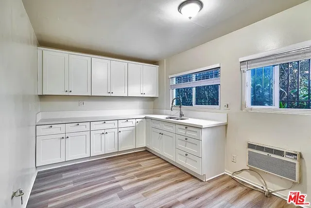 a kitchen with granite countertop white cabinets and white appliances