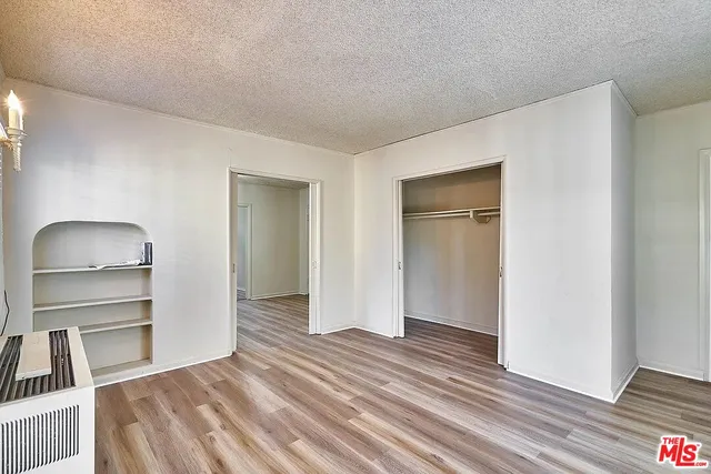 a view of a room with wooden floor and closet