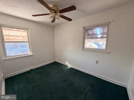a view of an empty room with wooden walls