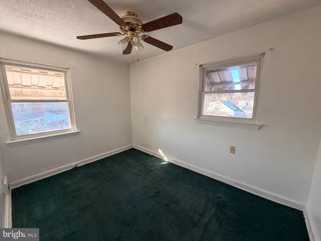 a view of an empty room with wooden walls