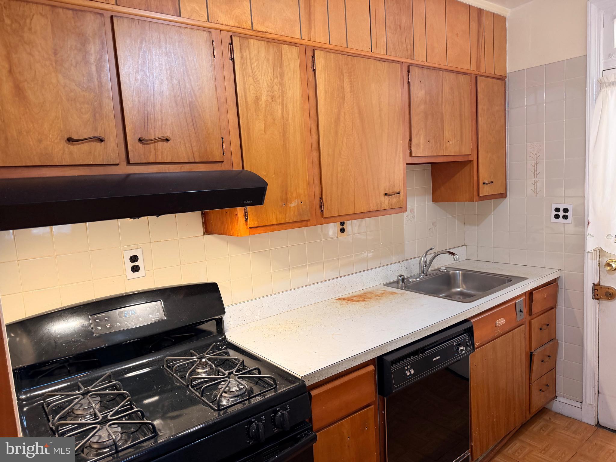 1001 30th Street Southeast Washington, DC 20019 - Photo 4 of 40 a kitchen with a sink cabinets and a stove top oven