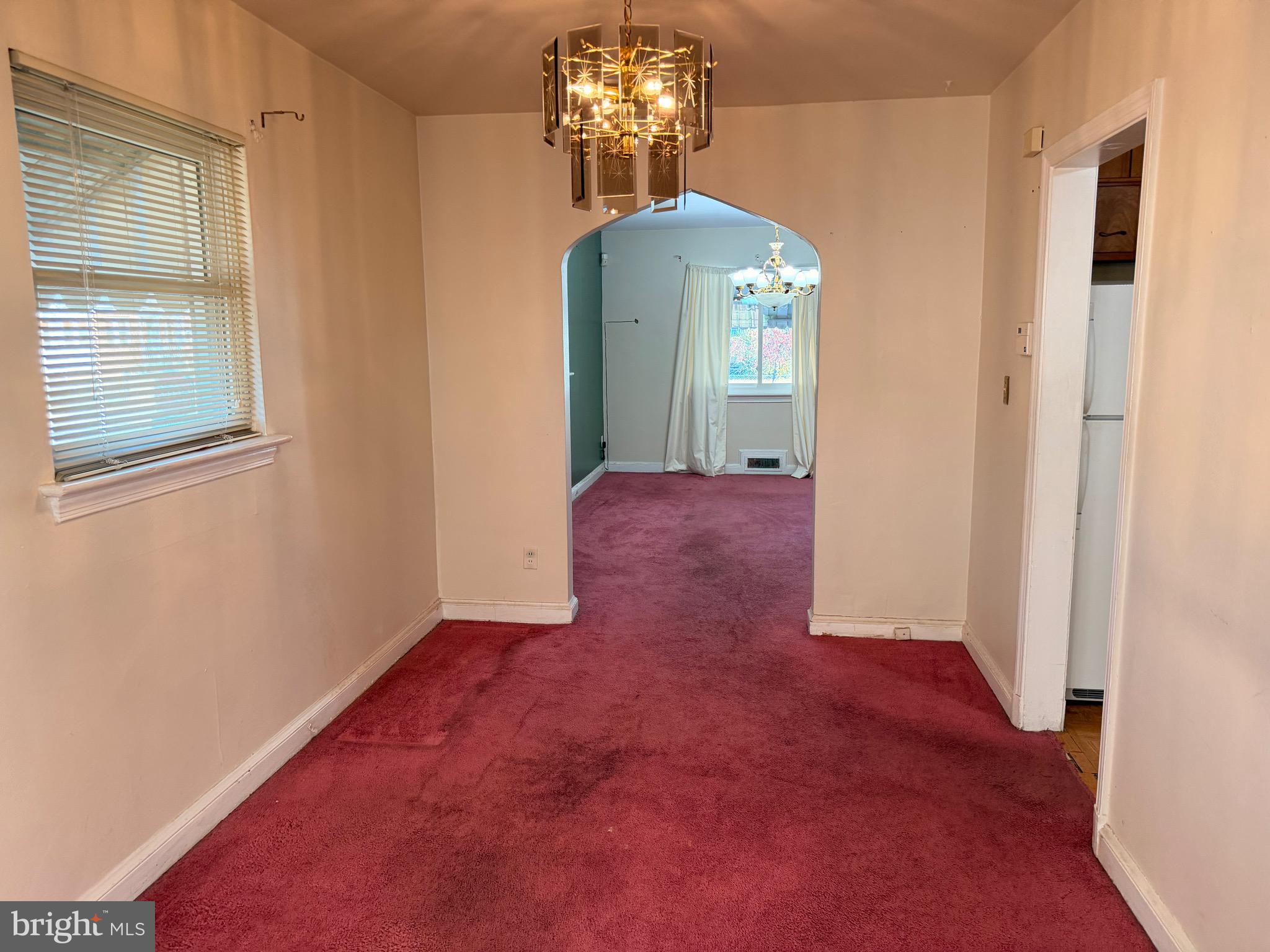 1001 30th Street Southeast Washington, DC 20019 - Photo 9 of 40 an empty room with chandelier fan and windows
