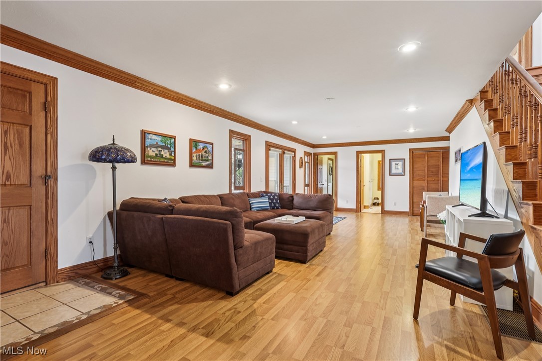 337 Cedar Point Road Sandusky, OH 44870 - Photo 16 of 50 Living area featuring ornamental molding, light wood-style flooring, stairs, and recessed lighting