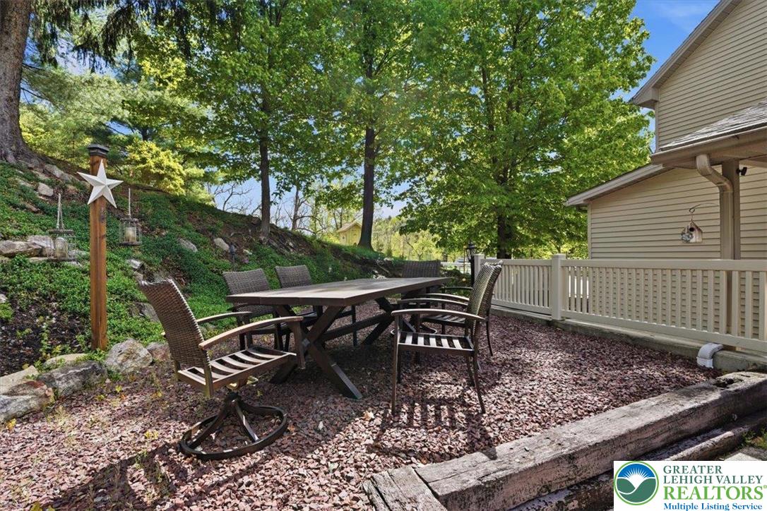 4880 Little Gap Road Kunkletown, PA 18058 - Photo 74 of 100 This private patio offers a delightful space for outdoor dining and relaxation amidst lush greenery.