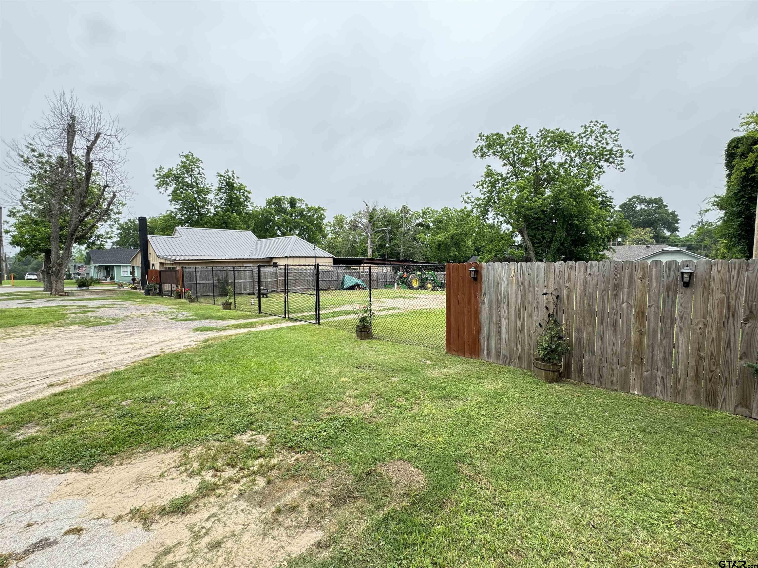 216 Rogers Avenue Henderson, TX 75654 - Photo 8 of 20 a view of a house with backyard and a sitting area