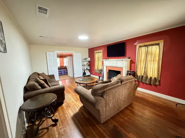 a living room with furniture a flat screen tv and a fireplace