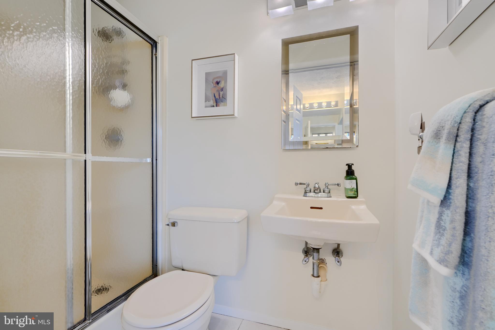19 Yew Road Baltimore, MD 21221 - Photo 27 of 36 a bathroom with a sink a toilet and shower