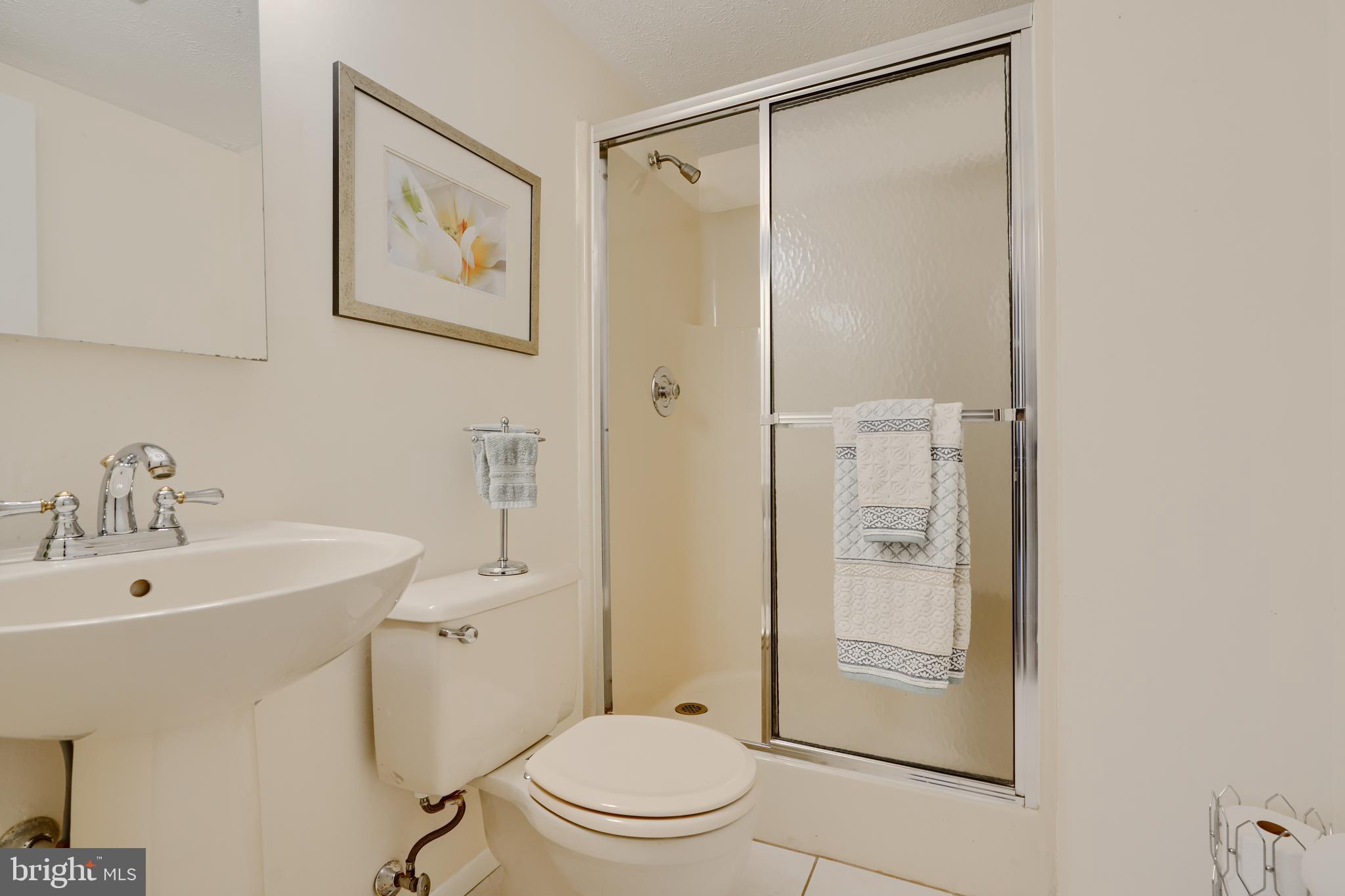 19 Yew Road Baltimore, MD 21221 - Photo 34 of 36 a bathroom with a shower a toilet and sink